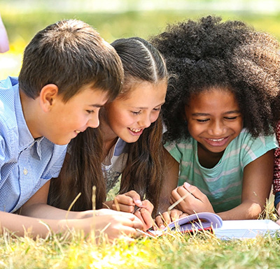 Students reading French books with an educator